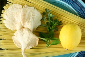 some of the ingredients: oyster mushrooms, herbs and a lemon 